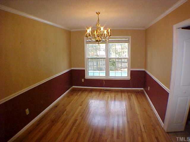 2320 Declaration Drive Raleigh, NC 27615 - Photo 3 of 10 a view of an empty room with wooden floor and a window