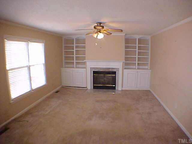 2320 Declaration Drive Raleigh, NC 27615 - Photo 4 of 10 an empty room with windows and fireplace