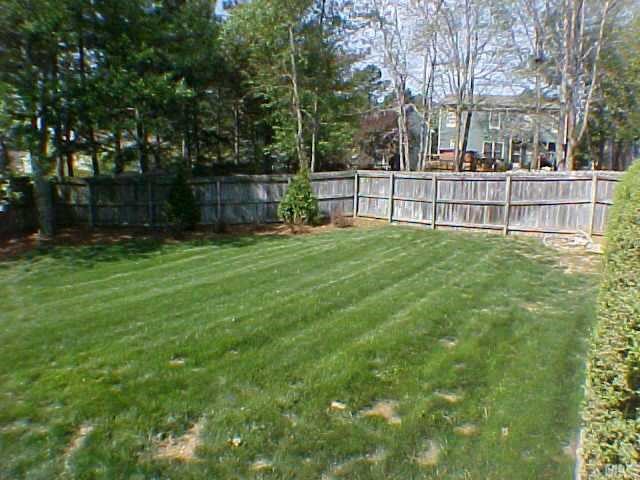 2320 Declaration Drive Raleigh, NC 27615 - Photo 10 of 10 a view of a backyard with large trees and wooden fence