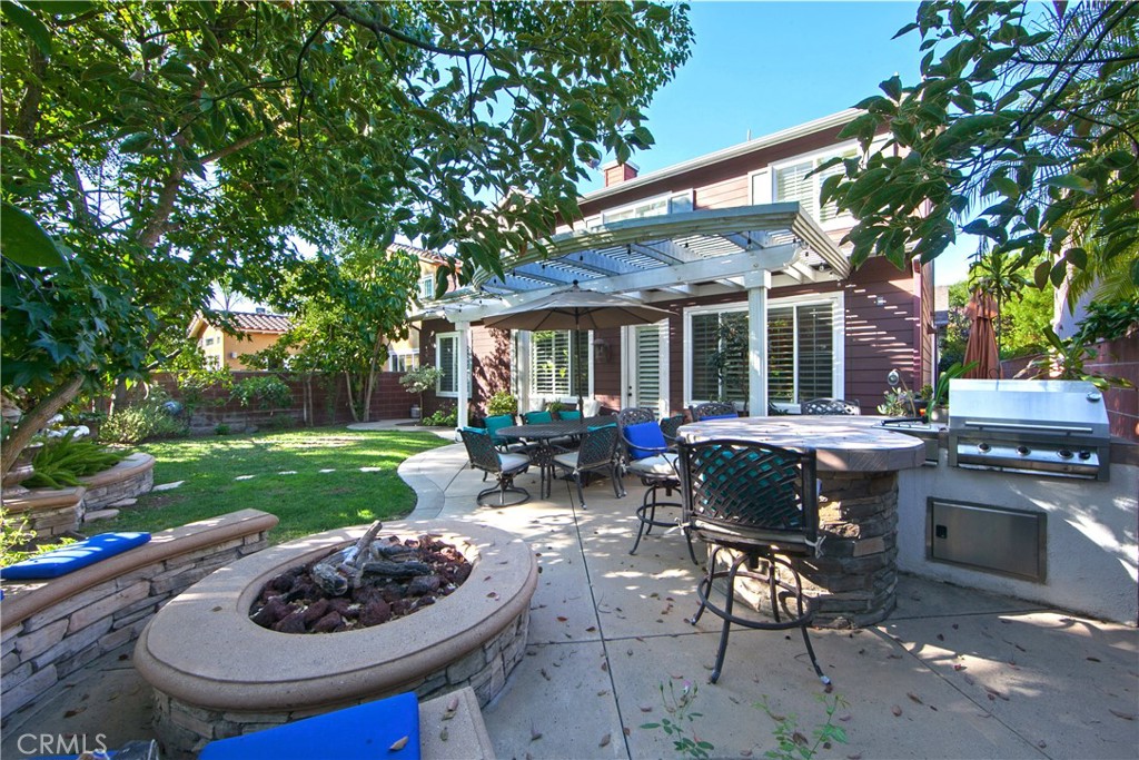 4 Sutherland Drive Ladera Ranch, CA 92694 - Photo 15 of 28 a view of a patio with table and chairs potted plants and a large tree