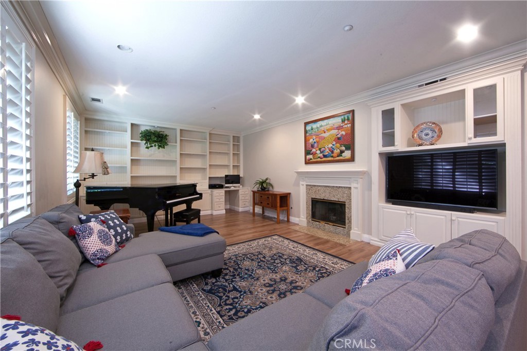 4 Sutherland Drive Ladera Ranch, CA 92694 - Photo 8 of 28 a living room with furniture a fireplace and a flat screen tv