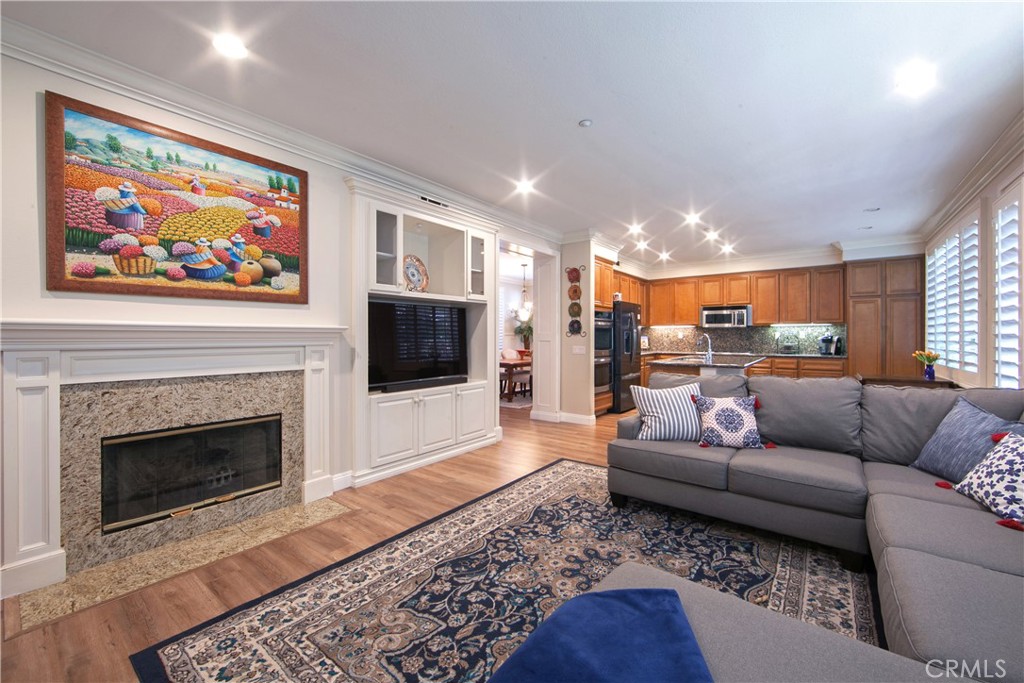 4 Sutherland Drive Ladera Ranch, CA 92694 - Photo 10 of 28 a living room with furniture a flat screen tv and a fireplace