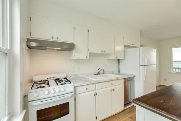 a kitchen with appliances cabinets and a sink