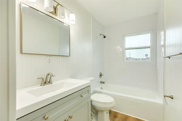 a bathroom with a sink mirror toilet and bathtub