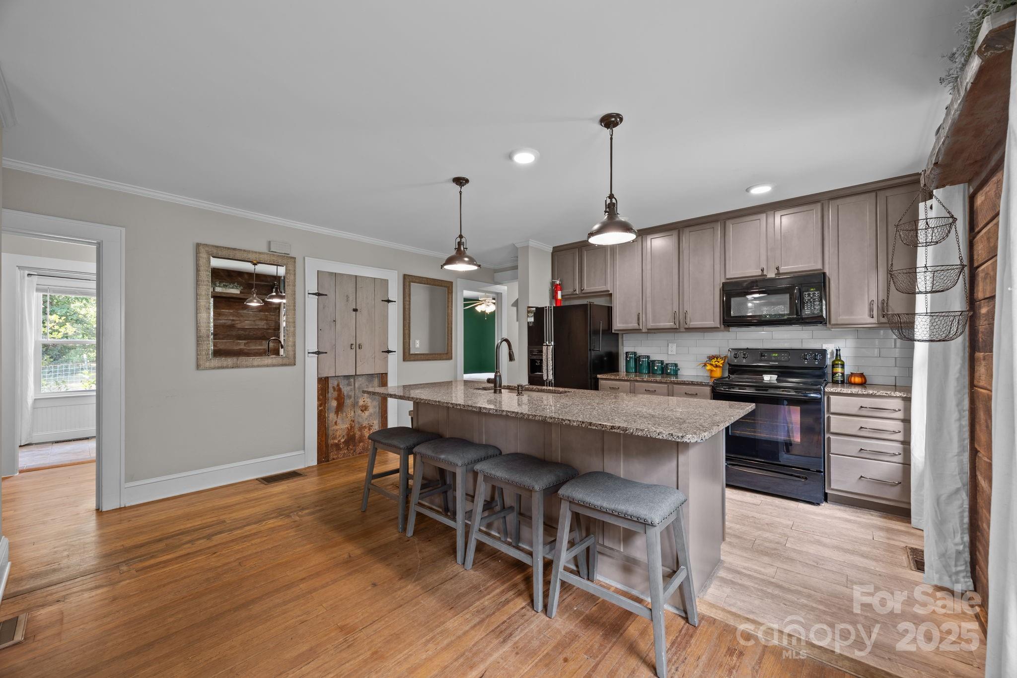 300 Gap Creek Road Fletcher, NC 28732 - Photo 19 of 48 a large kitchen with kitchen island a dining table and chairs