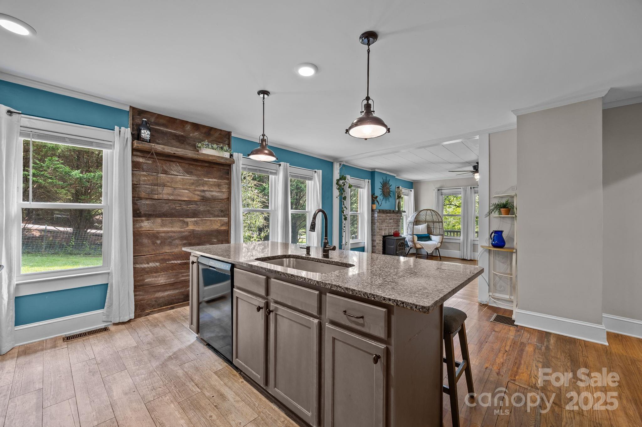 300 Gap Creek Road Fletcher, NC 28732 - Photo 21 of 48 a kitchen with kitchen island a sink stove and wooden floor