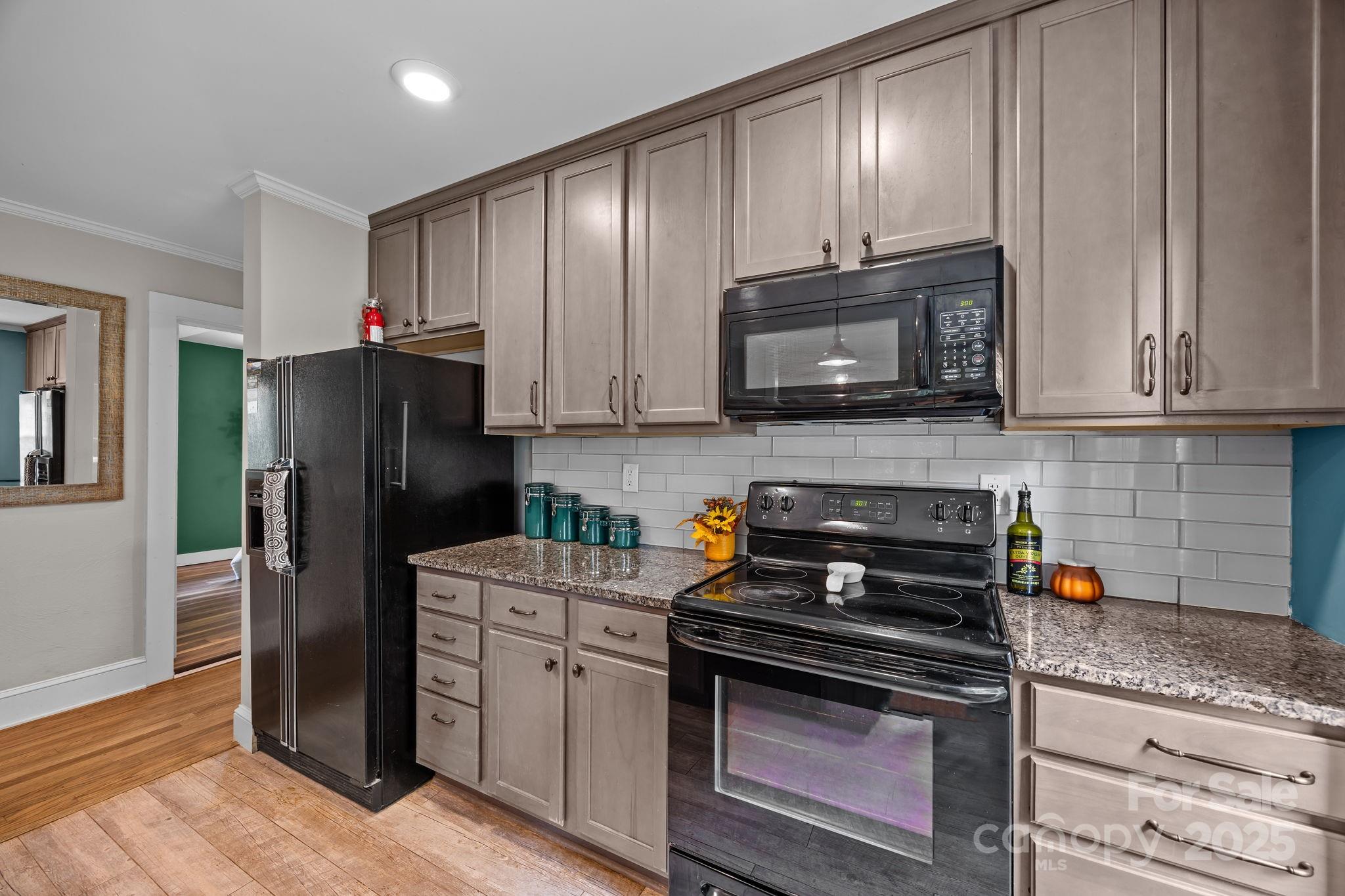 300 Gap Creek Road Fletcher, NC 28732 - Photo 23 of 48 a kitchen with stainless steel appliances granite countertop white cabinets a refrigerator and a stove top oven