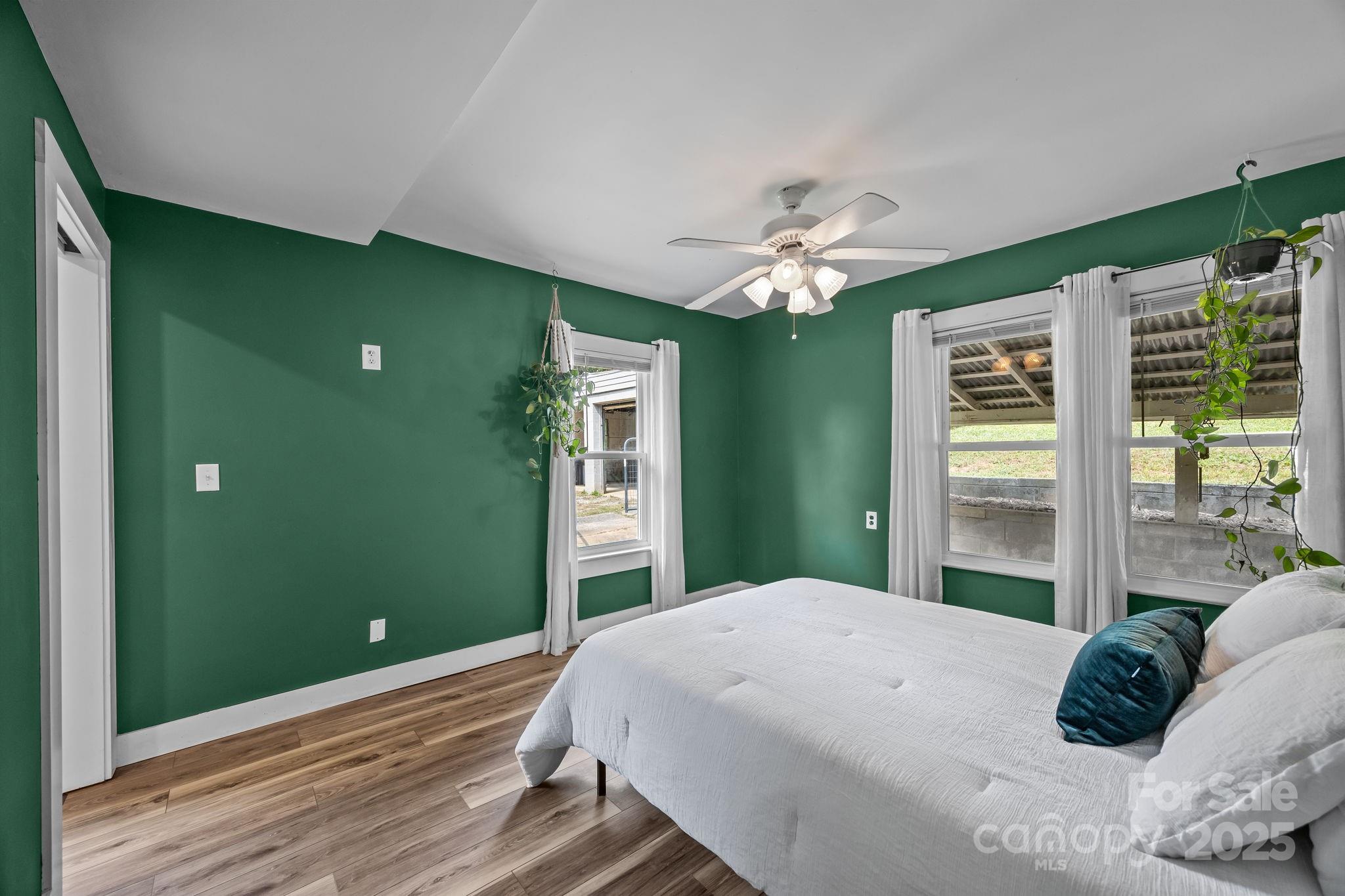 300 Gap Creek Road Fletcher, NC 28732 - Photo 27 of 48 a bedroom with a large bed and a chandelier