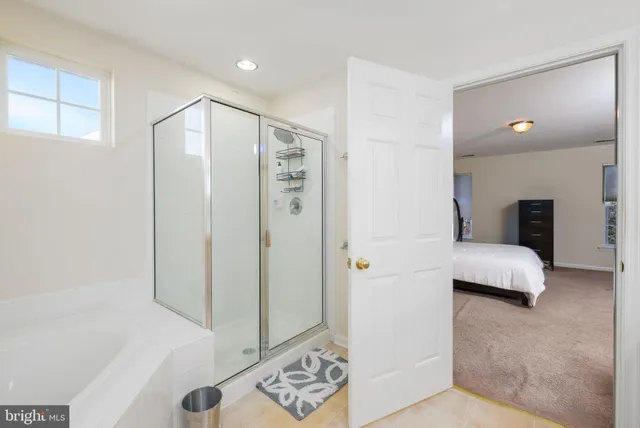 a en suite bathroom with a shower and a tub