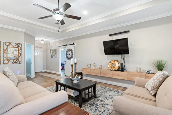 a living room with furniture and a flat screen tv