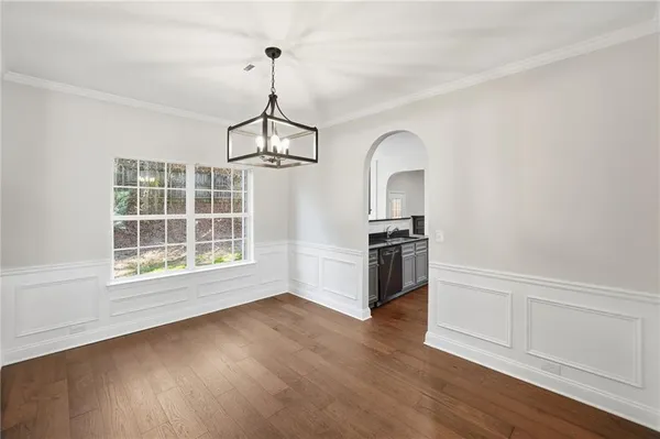 a view of a room with wooden floor staircase and a ceiling fan