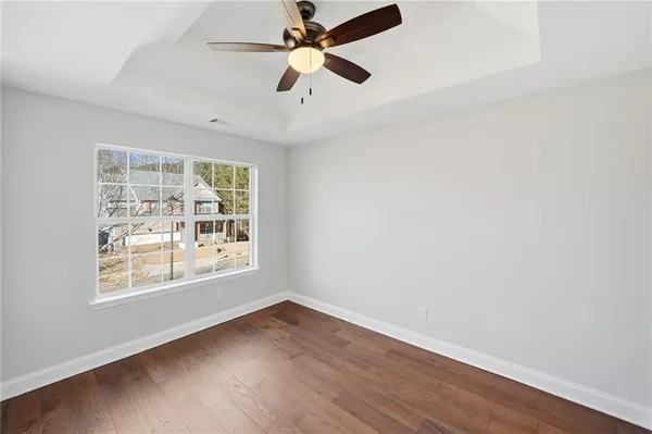 wooden floor in an empty room with a window