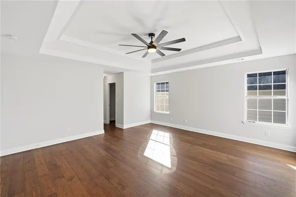 a view of a hallway with wooden floor and entryway
