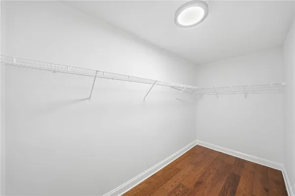 a spacious bathroom with a bathtub sink and mirror