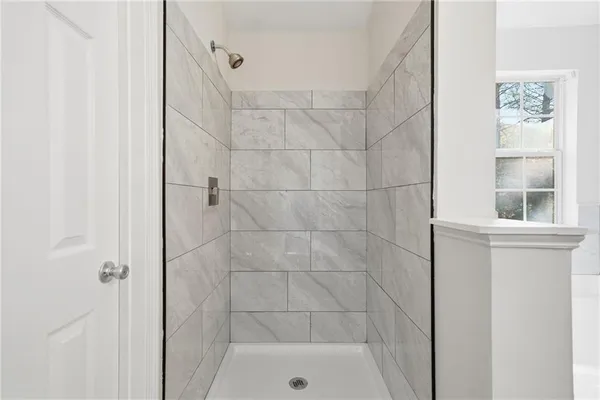 a white bath tub sitting next to a window