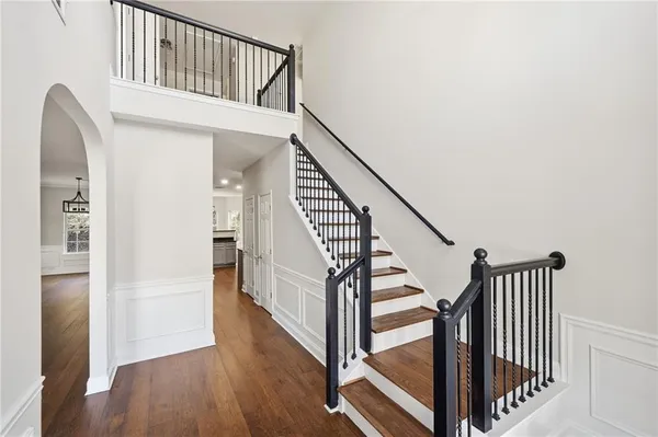 a view of an entryway with wooden floor and door
