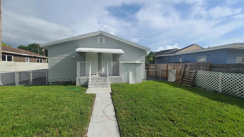 2519 West Walnut Street Tampa, FL 33607 - Photo 12 of 19 a front view of a house with a yard