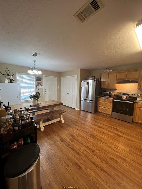 11349 North Dowling Road College Station, TX 77845 - Photo 4 of 16 a kitchen with stainless steel appliances granite countertop a stove and a refrigerator
