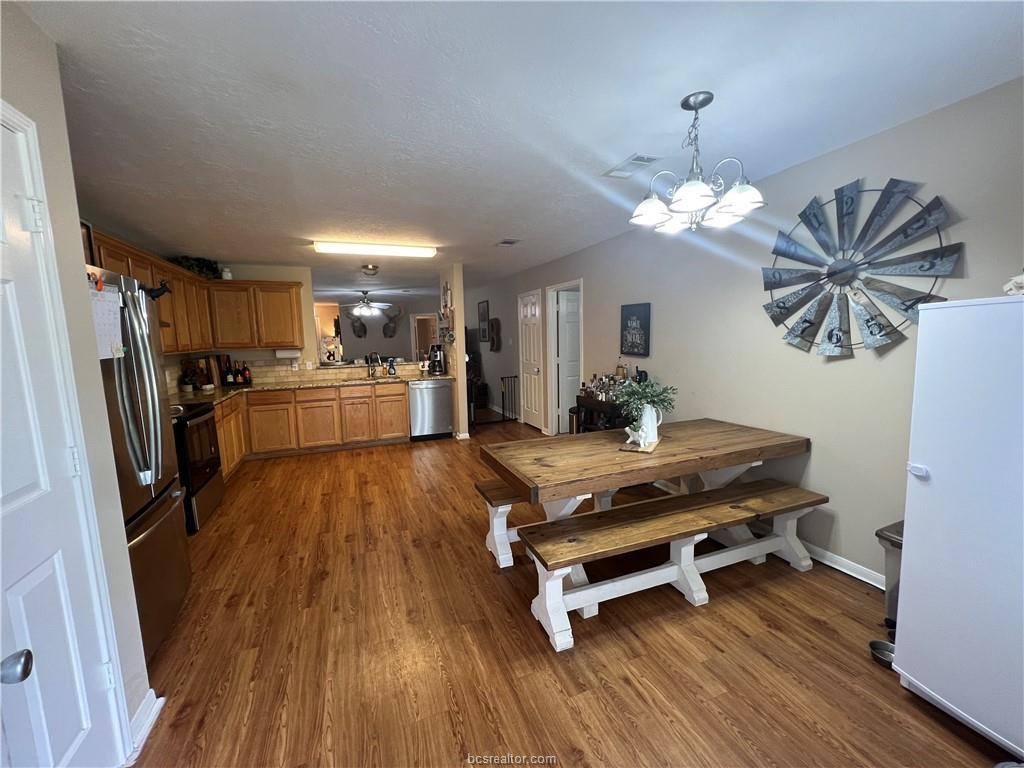 11349 North Dowling Road College Station, TX 77845 - Photo 6 of 16 a room with wooden floors pool table and stainless steel appliances