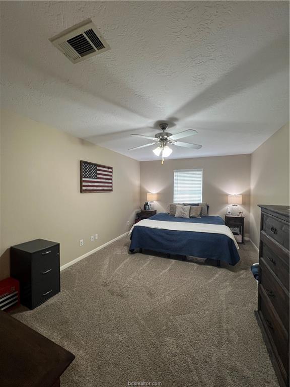 11349 North Dowling Road College Station, TX 77845 - Photo 7 of 16 a bedroom with a bed and a ceiling fan