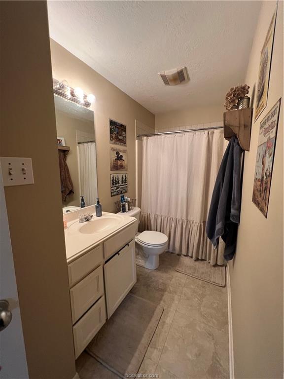11349 North Dowling Road College Station, TX 77845 - Photo 8 of 16 a bathroom with a double vanity sink toilet and shower