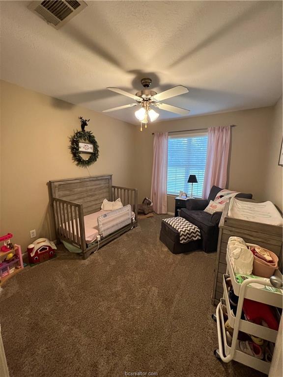 11349 North Dowling Road College Station, TX 77845 - Photo 9 of 16 a bedroom with bed and a chandelier
