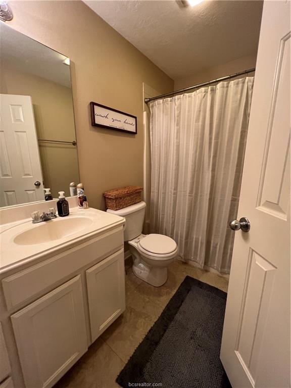 11349 North Dowling Road College Station, TX 77845 - Photo 10 of 16 a bathroom with a sink a toilet and a mirror