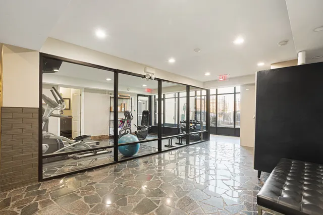 a lobby with furniture and floor to ceiling window