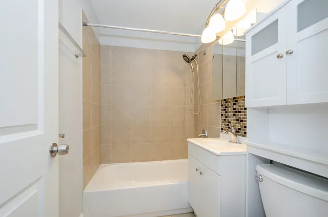 a bathroom with a bathtub a sink and a shower