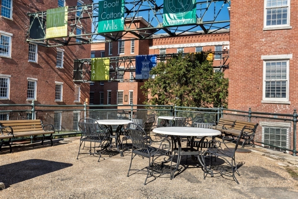 130 John Street, Unit 142 Lowell, MA 01852 - Photo 11 of 15 a view of a patio with table and chairs and potted plants