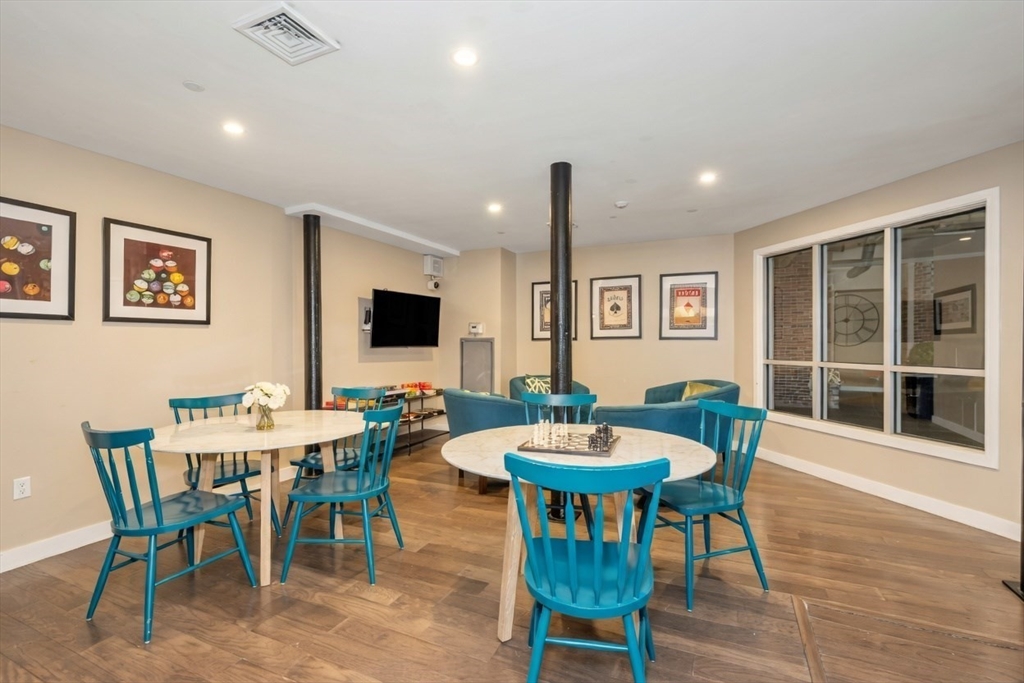 130 John Street, Unit 142 Lowell, MA 01852 - Photo 12 of 15 a view of a dining room with furniture and wooden floor
