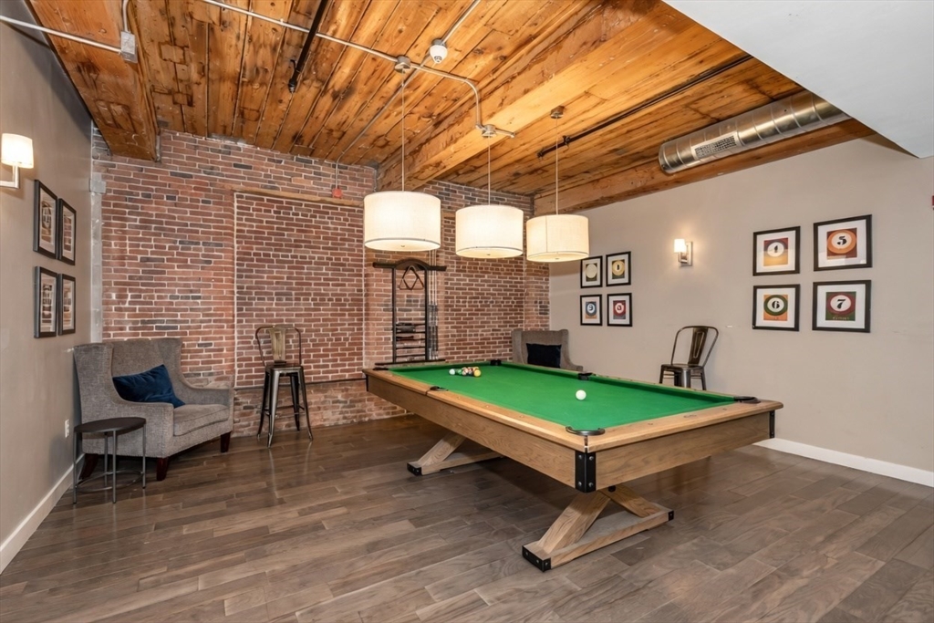 130 John Street, Unit 142 Lowell, MA 01852 - Photo 13 of 15 a living room with furniture and a pool table