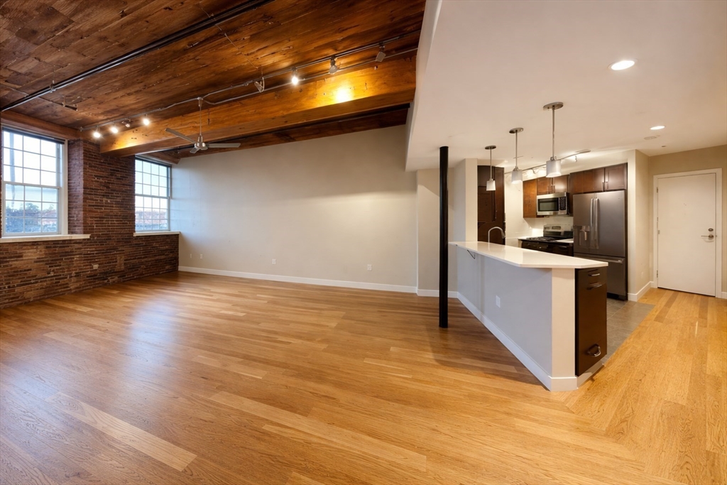 130 John Street, Unit 142 Lowell, MA 01852 - Photo 2 of 15 a view of a kitchen with a sink and a stove top oven