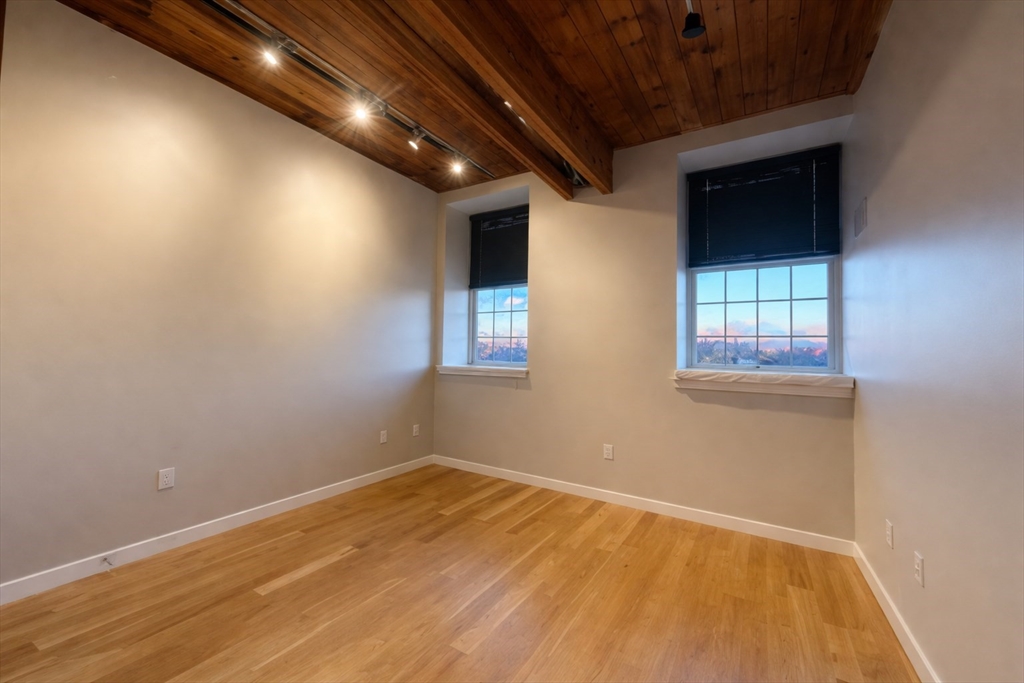 130 John Street, Unit 142 Lowell, MA 01852 - Photo 6 of 15 a view of empty room with wooden floor and fan
