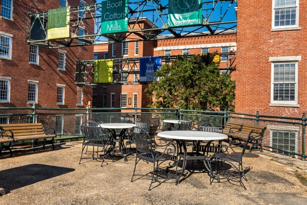 130 John Street, Unit 142 Lowell, MA 01852 - Photo 9 of 15 a view of a patio with table and chairs and potted plants