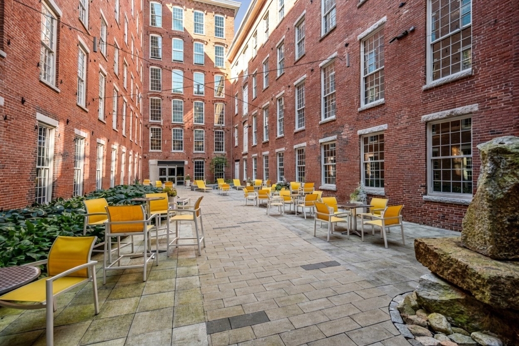 130 John Street, Unit 142 Lowell, MA 01852 - Photo 10 of 15 a row of blue chairs sitting in front of a building