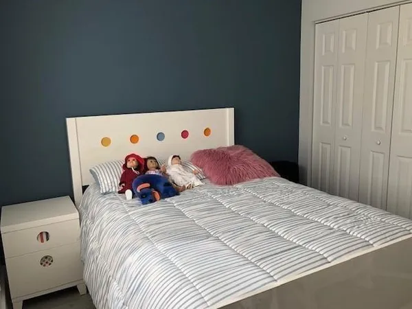 a bed room with a bed and a window