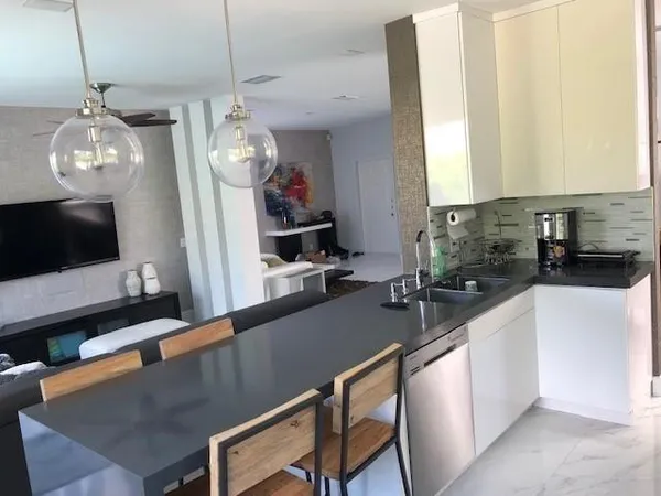 a kitchen with sink and refrigerator