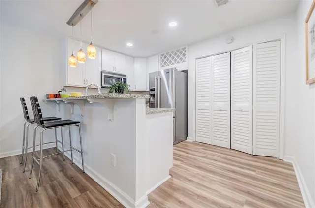 a kitchen with stainless steel appliances a refrigerator and a stove top oven