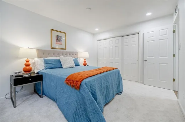 a bedroom with a bed and a painting on the wall