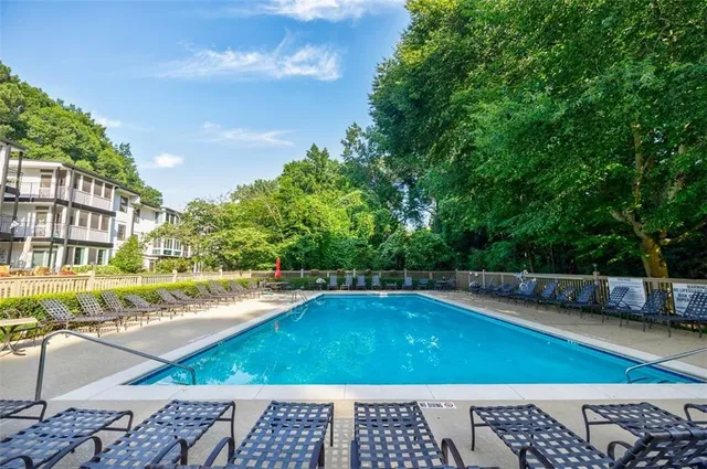 a view of a swimming pool with an outdoor space and seating area