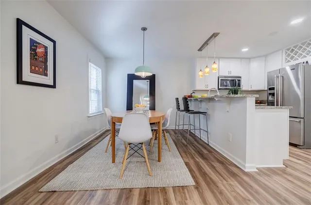 a view of a dining room with furniture window and wooden floor