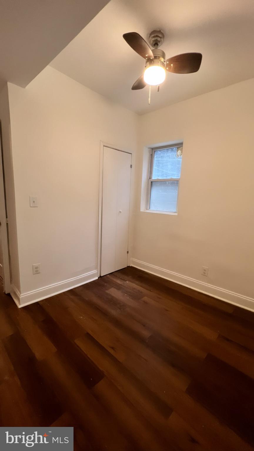 1345 1st Street Northwest, Unit 1 Washington, DC 20001 - Photo 16 of 17 an empty room with wooden floor ceiling fan and window