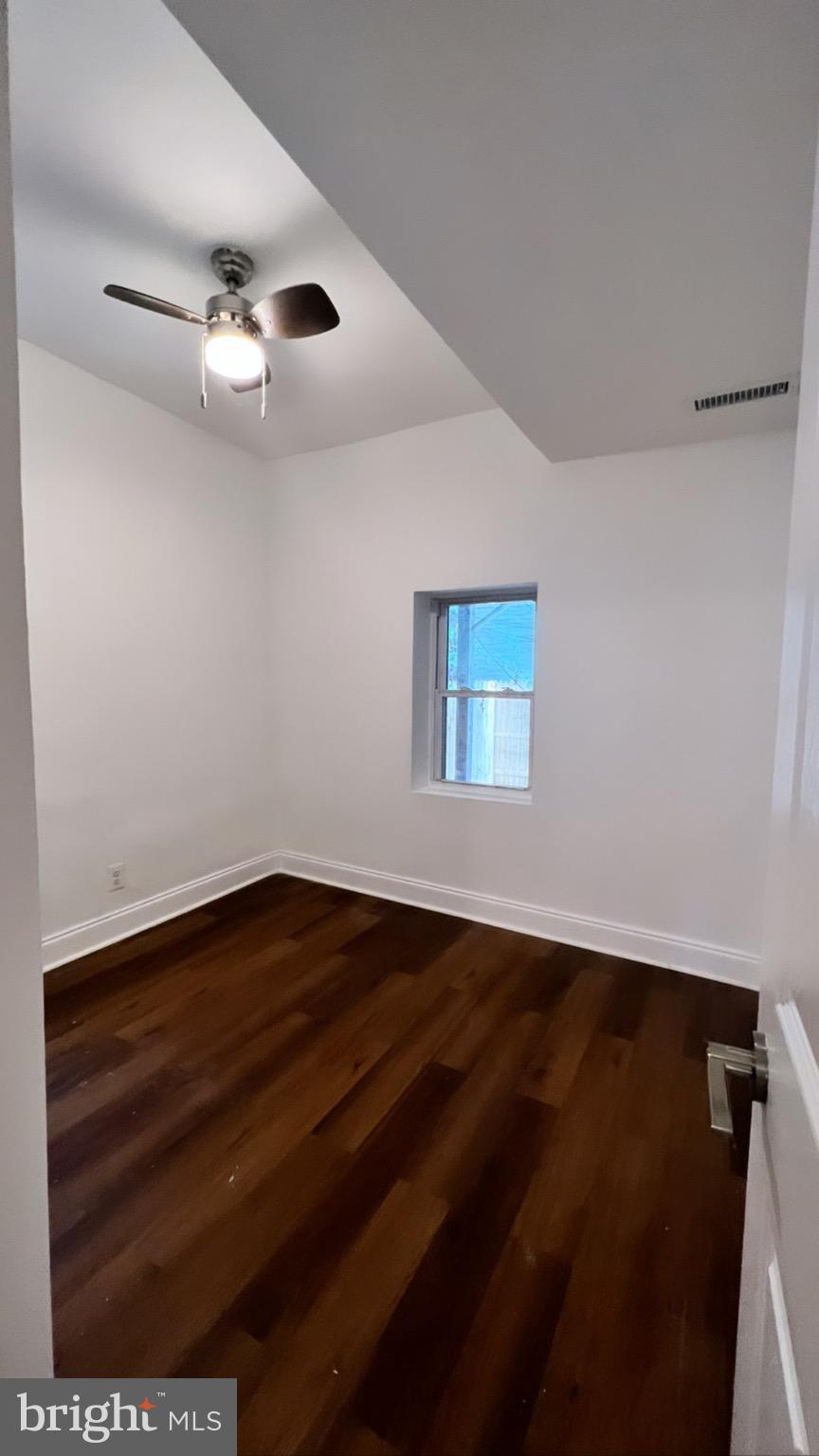 1345 1st Street Northwest, Unit 1 Washington, DC 20001 - Photo 17 of 17 a view of an empty room with wooden floor and a window