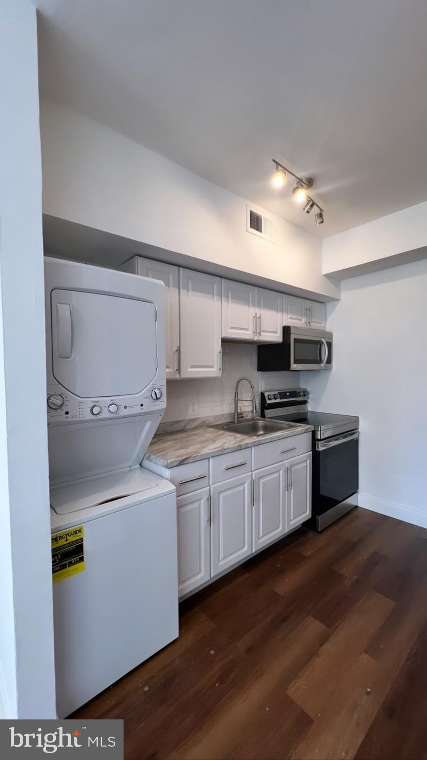 1345 1st Street Northwest, Unit 1 Washington, DC 20001 - Photo 7 of 17 a kitchen with granite countertop a sink and cabinets