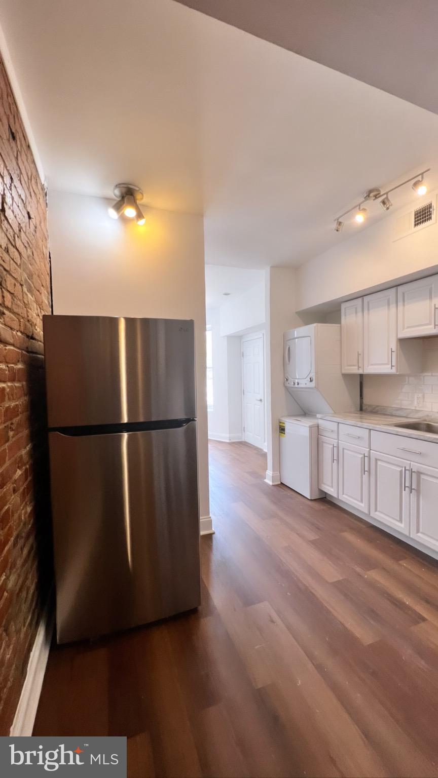 1345 1st Street Northwest, Unit 1 Washington, DC 20001 - Photo 8 of 17 a view of a refrigerator in kitchen and wooden floor