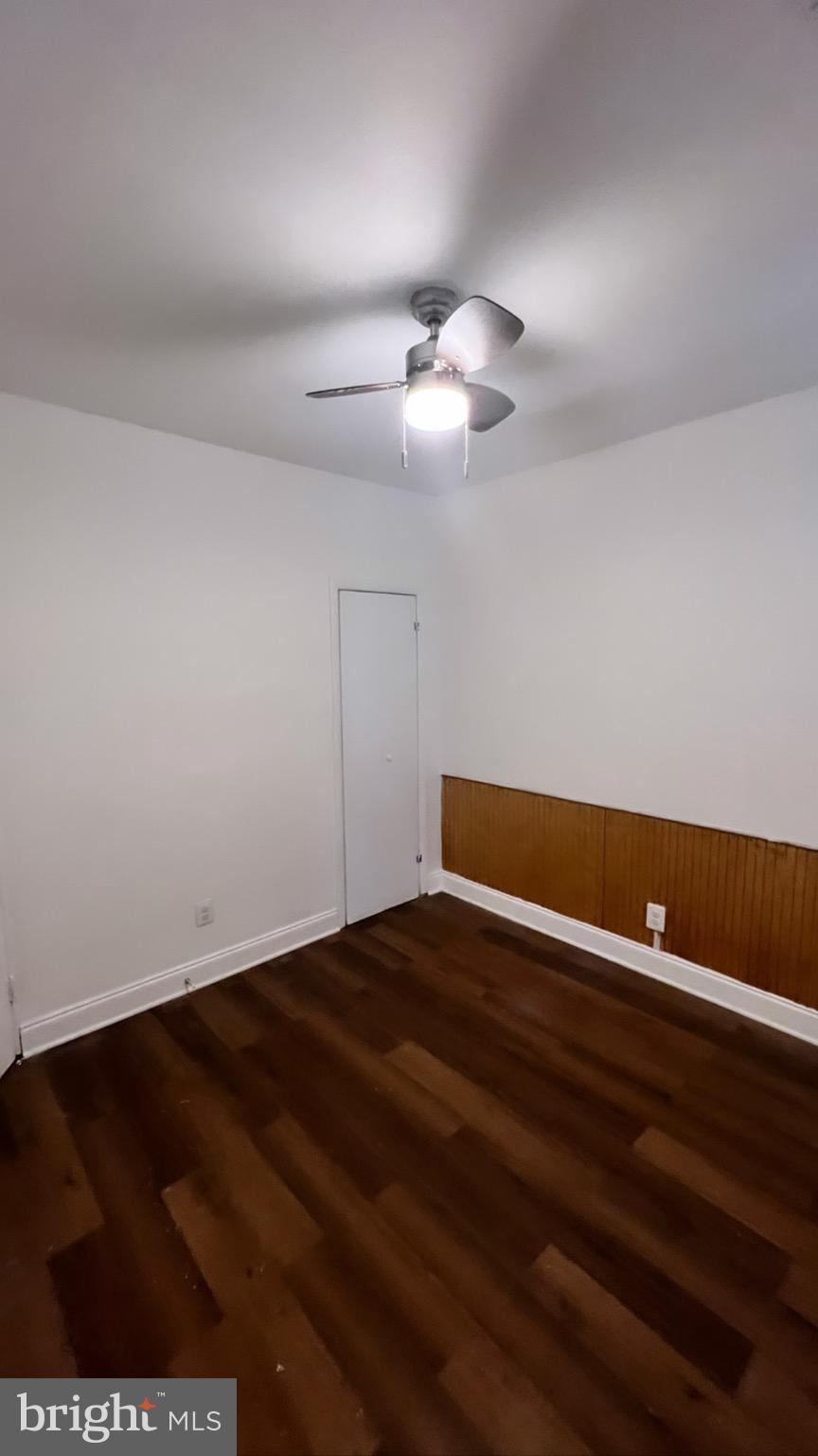 1345 1st Street Northwest, Unit 1 Washington, DC 20001 - Photo 10 of 17 an empty room with a ceiling fan and wooden floor