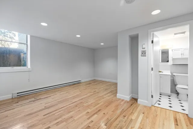 a view of empty room with wooden floor
