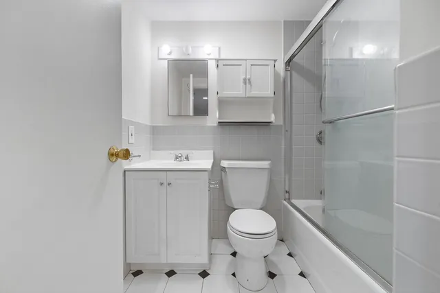 a bathroom with a toilet sink and shower
