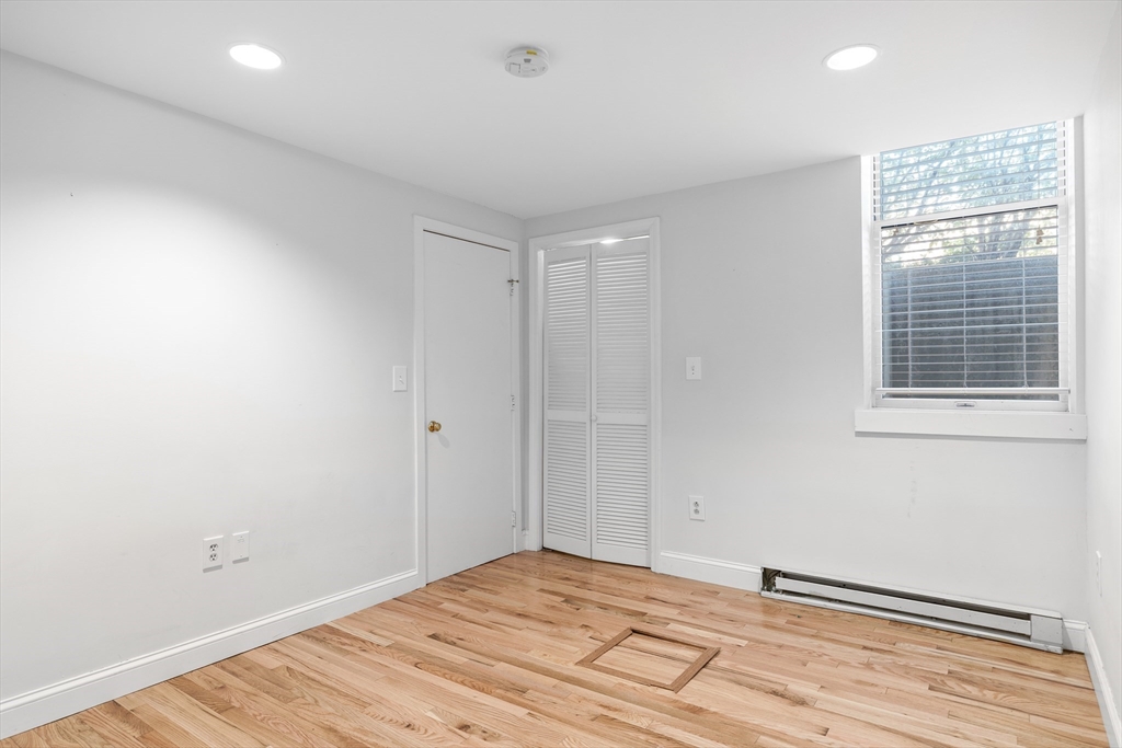 1763 Beacon Street, Unit A Brookline, MA 02445 - Photo 6 of 20 a big room with wooden floor and windows